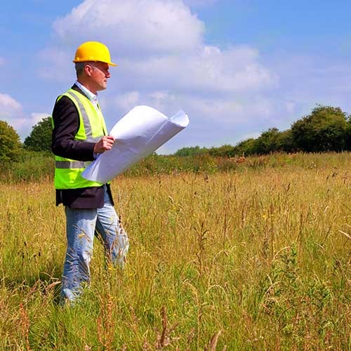 Man in a field surveying